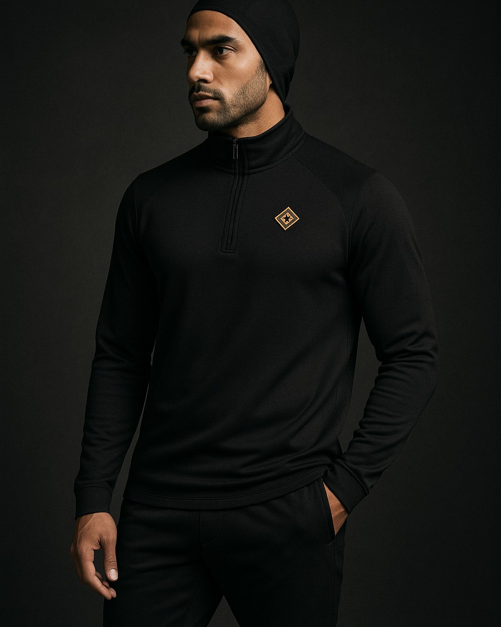 Modest quarter-zip with gold collar mark and tapered jogger
